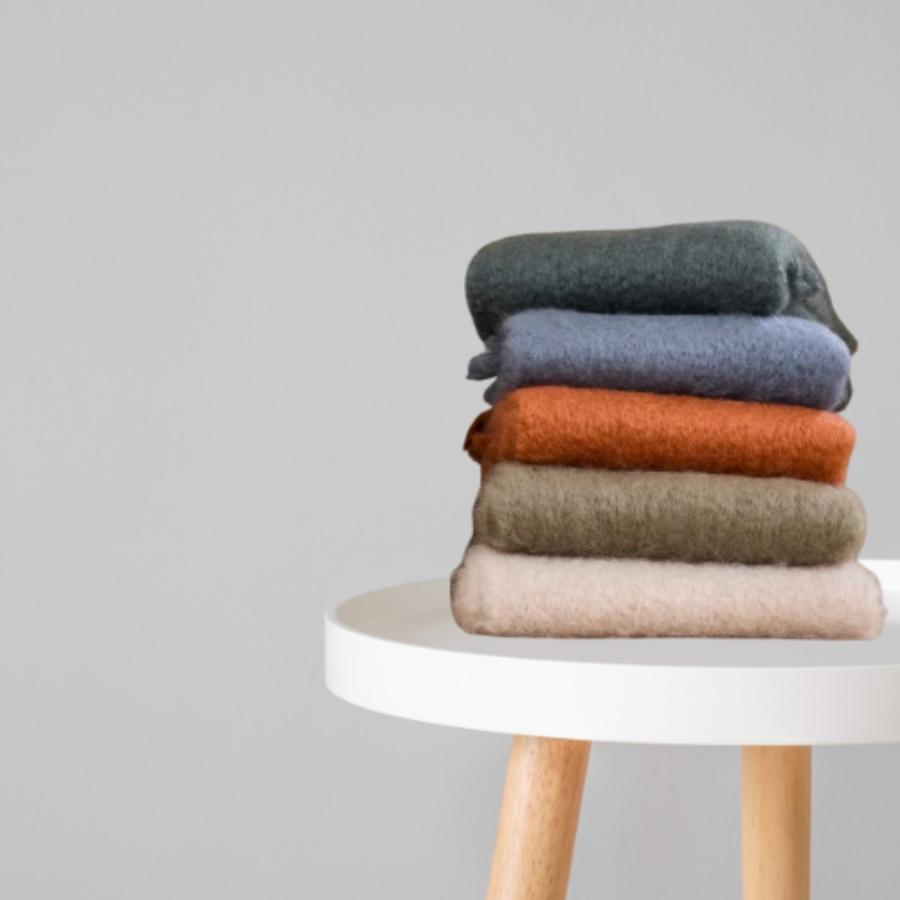 Mantas Ezcaray blankets folded on a table